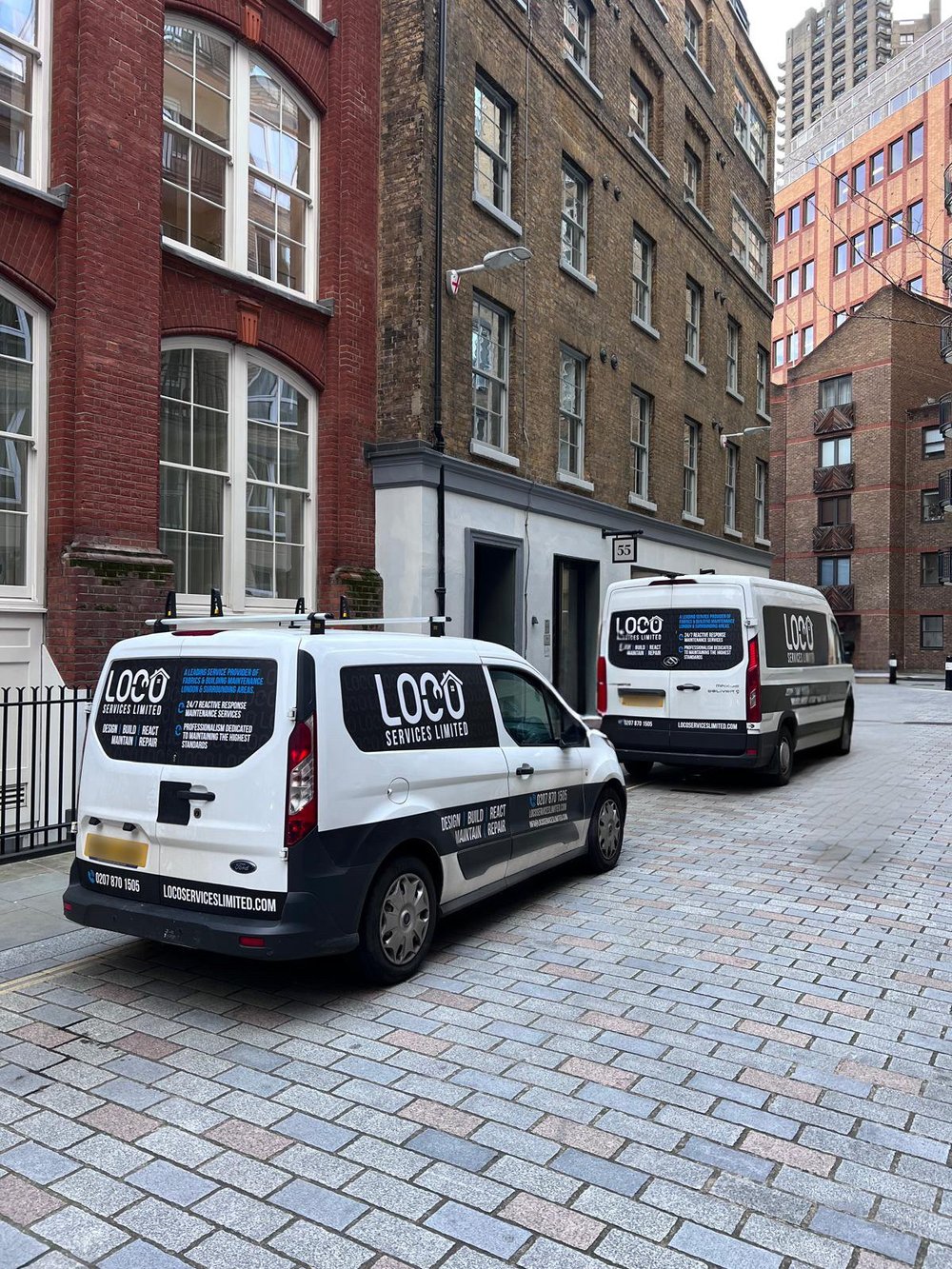 LOCO service vans parked on a London street